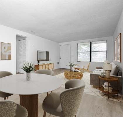 a living room and dining room with a table and chairs