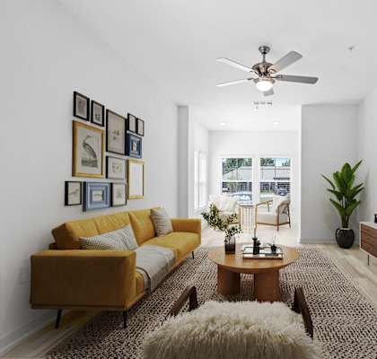 a living room with a yellow couch and a tv