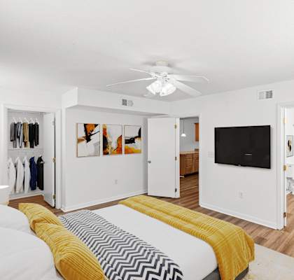 a bedroom with a bed and a ceiling fan