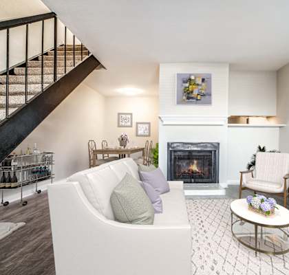 a living room with a white couch and a fireplace
