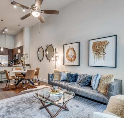 a living room with couches and a glass coffee table