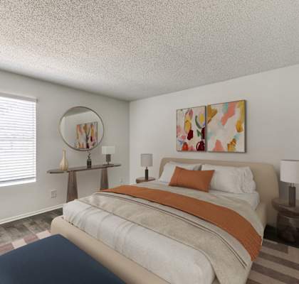 a bedroom with a bed with an orange and white comforter