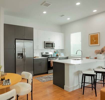 a rendering of a kitchen and dining room with a geometric wall mural