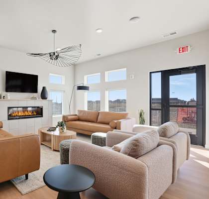 A living room with a fireplace and a flat screen TV.