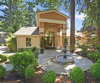 A house with a fountain in the front yard.