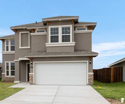 A two-story house with a garage and a driveway.