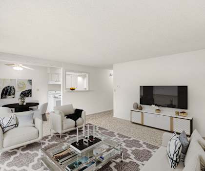a living room with white furniture and a flat screen tv
