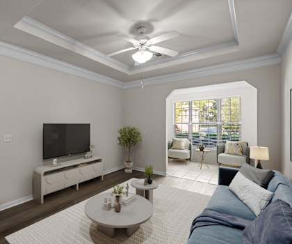 A living room with a television, a sofa, and a coffee table.
