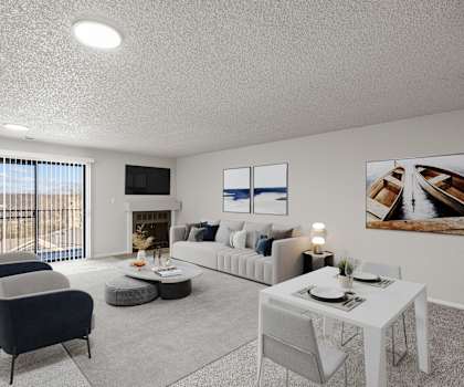 A living room with a grey sofa, a white coffee table, and a fireplace.