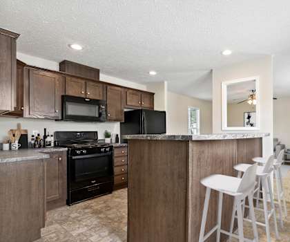 A kitchen with a black oven and black microwave.