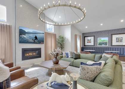 A modern living room with a fireplace and a large painting of a person running on the wall.