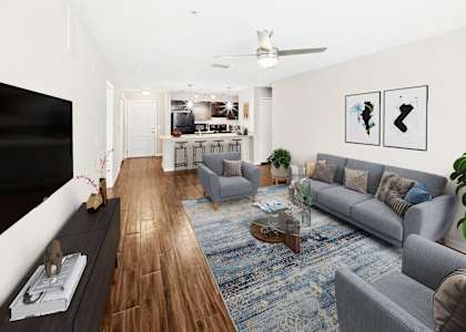 Summerset Affordable Apartments A living room with a grey couch and a coffee table.