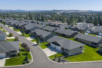 A suburban neighborhood with houses and a road.