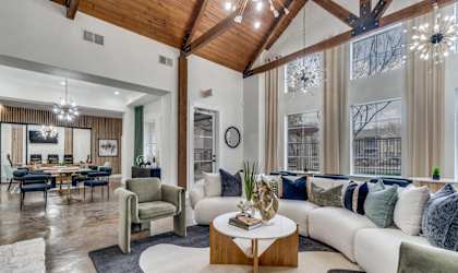 a living room with couches and chairs and a table