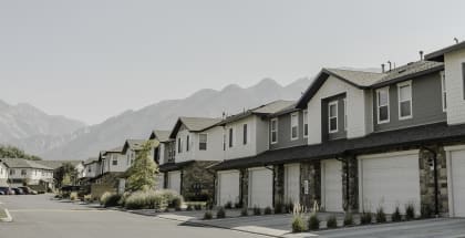 a row of houses with mountains in the background