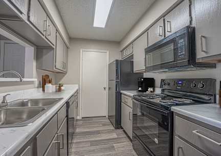 a dining area with a table and chairs and a kitchen at Paces Crossing, Denton, 76210