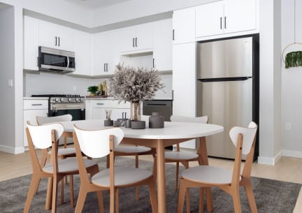 a kitchen and dining room with a table and chairs