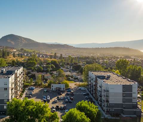 an aerial view of a city with a mountain in the background