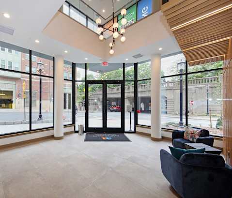 A modern waiting area with a black mat on the floor.