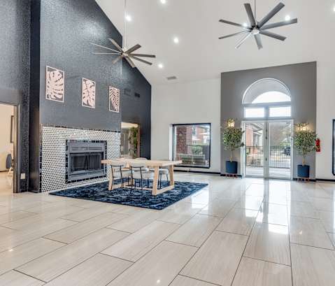A modern living room with a fireplace and a dining table.