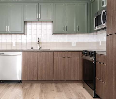 A kitchen with wooden cabinets and a white dishwasher.