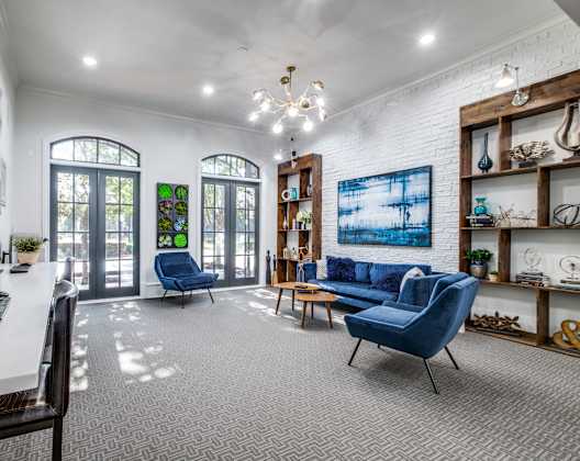 A room with a white desk and a blue chair.