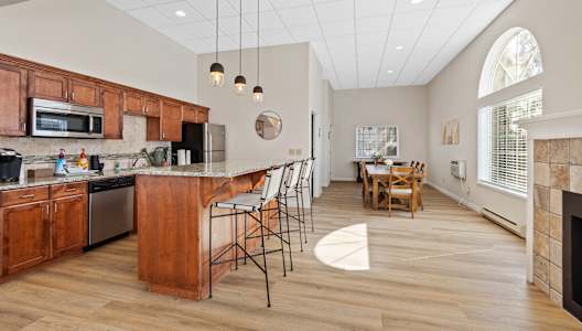 a kitchen with a large island and a dining room with a table