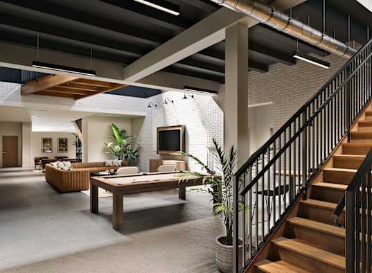 A modern interior with a staircase, a couch, a table, and a potted plant.