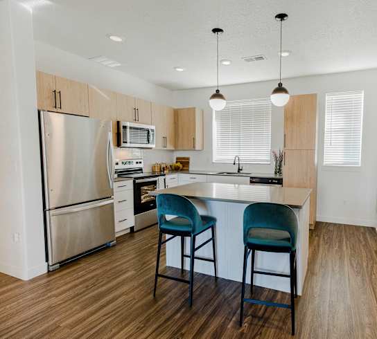 a kitchen with an island and stools