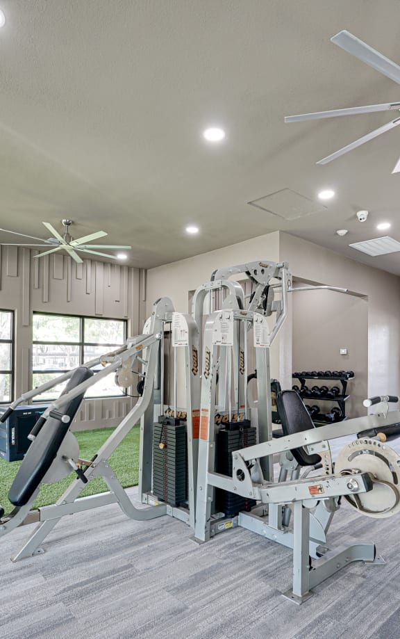 Gym with a large window and a ceiling fan  at Carmel Creekside, Texas