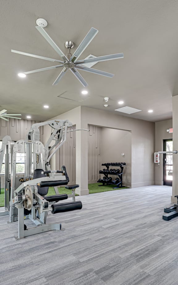 Fitness center with cardio equipment and grassy area  at Carmel Creekside, Fort Worth, 76137