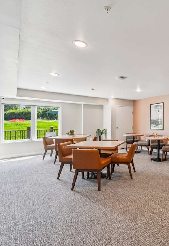 A room with a long table and chairs.