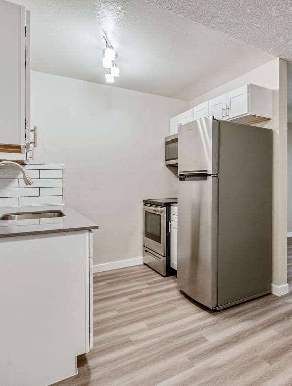 a kitchen with stainless steel appliances and a sink