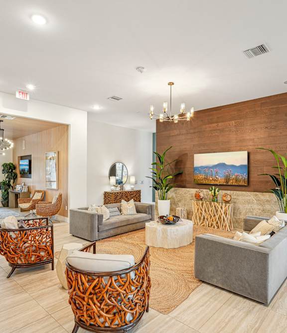 A modern living room with a wooden wall and a grey couch at Edge75, Naples, Florida 34104