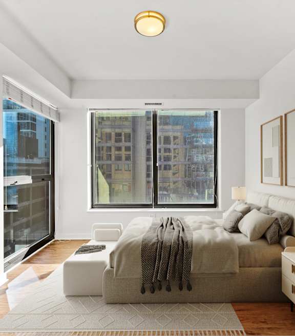 A bedroom with a large bed and a window overlooking a cityscape at Chateau on Wells, Chicago, Illinois