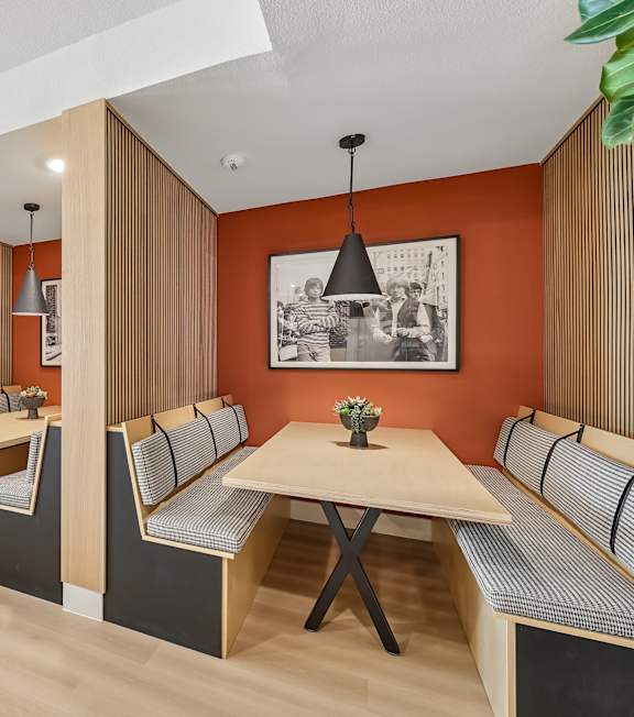 A living room with a white couch, a coffee table, and a ceiling fan. at Augustine, Austin, TX
