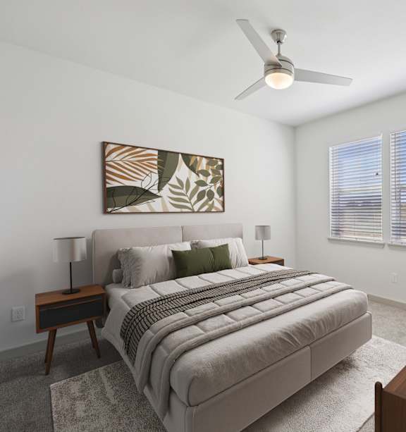 A bedroom with a large bed and a ceiling fan.