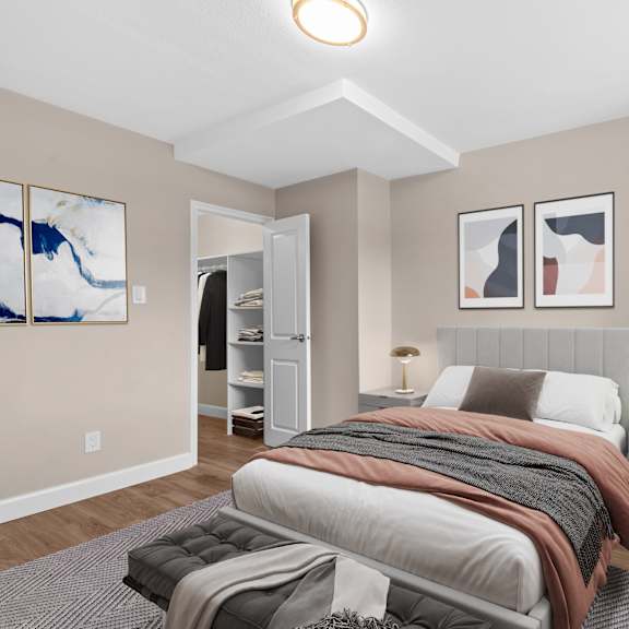 A bedroom with a large bed and a painting on the wall.