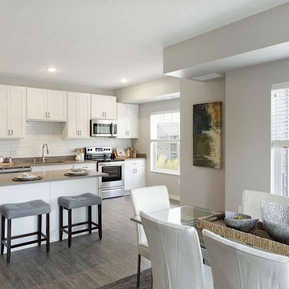 A modern kitchen with white cabinets and a large island.