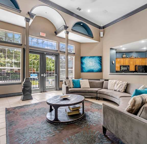 A living room with a grey couch and a coffee table. at Villas of Sorrento Apartments, Dallas, TX, 75241