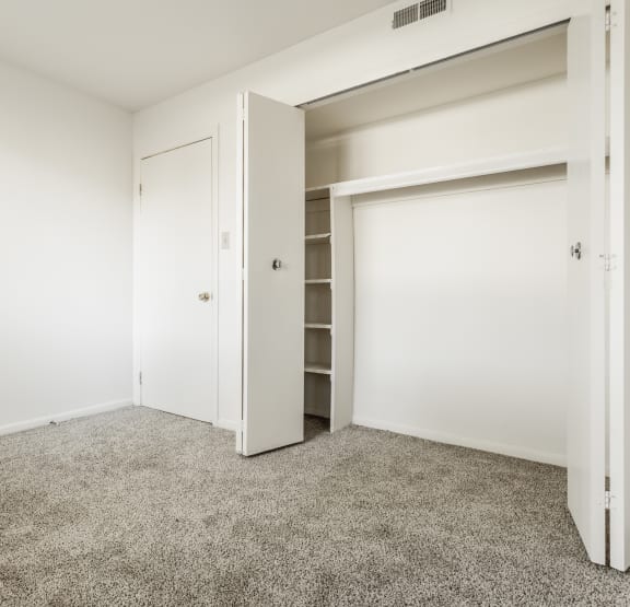 a bedroom with a bed and a ceiling fan at Polo Run Apartments, Greenwood, IN, 46142