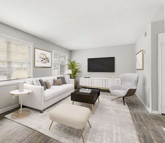 a living room with a white couch and a tv at Pinewood Townhomes in Tucker, Georgia 30084