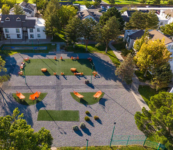 an aerial view of a playground in a neighborhood with trees