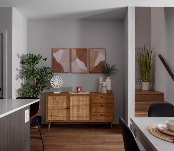 A modern kitchen with a wooden cabinet and a dining table set for two.