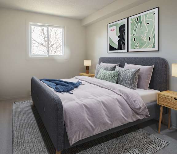 A bedroom with a bed, nightstand, and a painting on the wall.