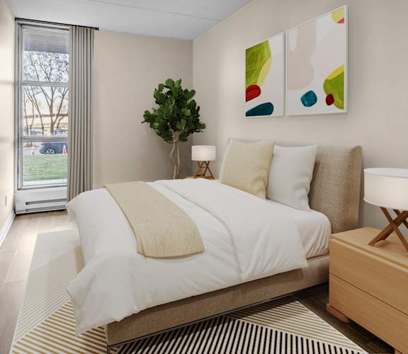 A bedroom with a large bed and a painting on the wall.