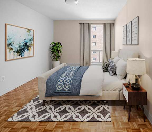 A bedroom with a large bed and a painting on the wall.