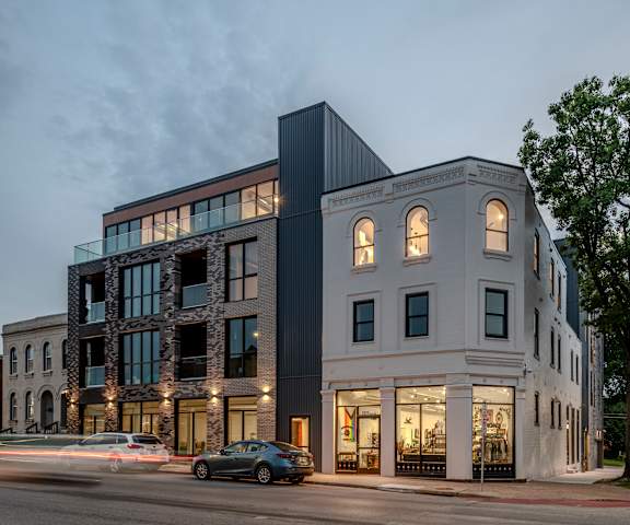a large building on a city street at dusk