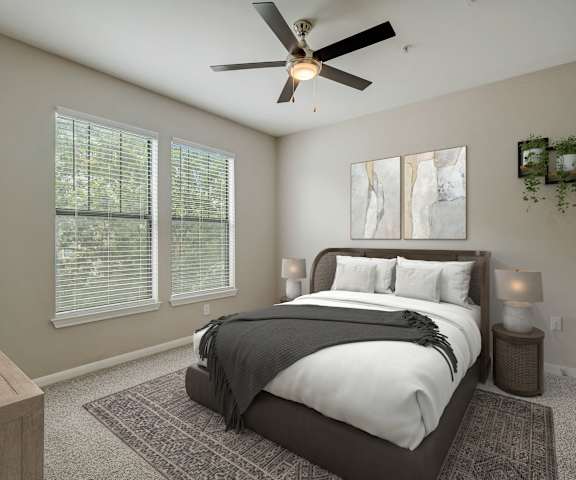 a bedroom with a large bed and a ceiling fan