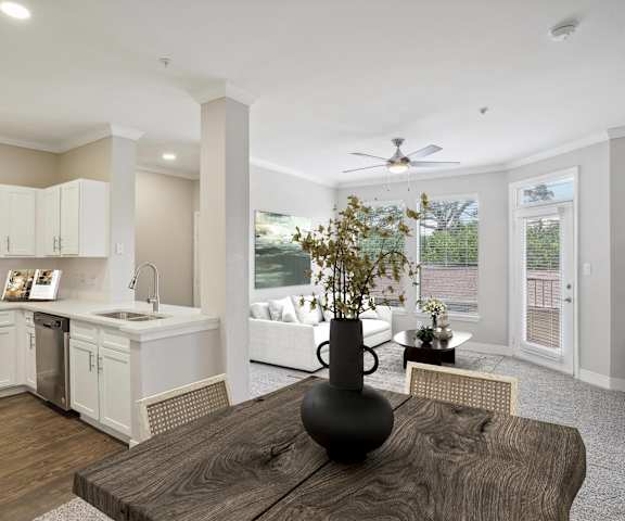 an open kitchen and living room with a large window and a table at The Verandah, Austin, TX, 78726